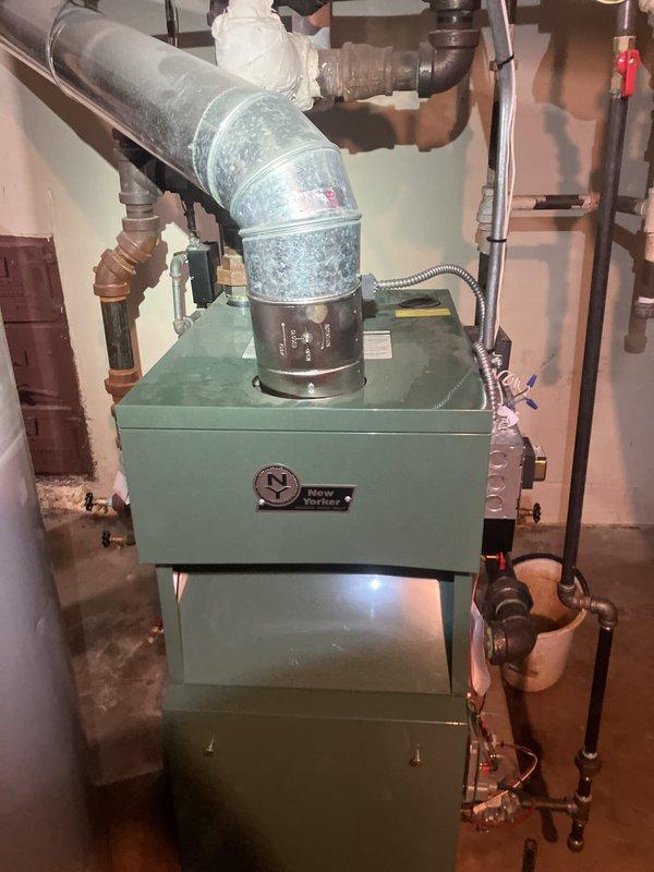 Performed comprehensive annual maintenance inspection on 10-year-old New Yorker boiler system located in basement. Replaced air filter per maintenance protocol and inspected all system components including heat exchanger, burner assembly, flue pipe, and associated plumbing connections. Verified proper operation of all safety controls, checked for signs of moisture accumulation on exhaust ductwork, and confirmed adequate ventilation. All copper piping, valves, and fittings inspected for leaks or corrosion. System operating within normal parameters with no immediate repairs required.