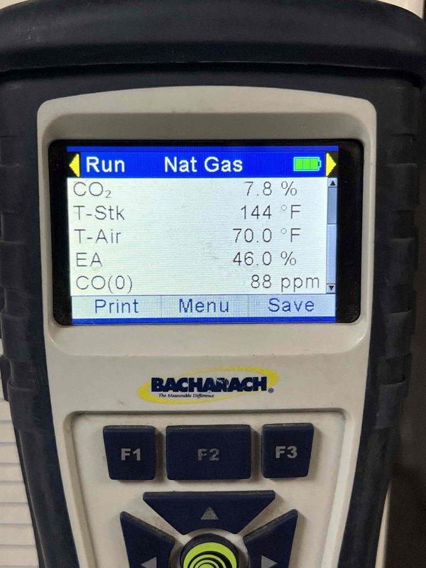 Completed comprehensive tune-up on 10+ year old natural gas furnace system located in basement. Performed combustion analysis using digital analyzer, recording CO2 levels at 7.8%, stack temperature at 144°F, ambient air temperature at 70.0°F, excess air at 46.0%, and carbon monoxide at 88 ppm. Inspected internal components including heat exchanger, blower assembly, and burner chamber; noted minor discoloration on heat exchanger surface. Evaluated integrated humidifier operation and verified proper function. Checked thermostat calibration and response. Inspected hot water tank as part of complete system assessment. All systems operating within acceptable parameters; unit cleared for continued operation.