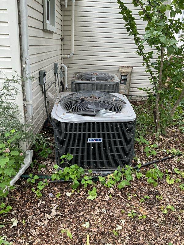 Provided equipment replacement estimate for 3-year-old AirQuest air conditioning system that sustained storm damage. Unit currently operational but compromised; located at exterior with utility room air handler. Documented existing dual condenser configuration, electrical panel specifications, and refrigerant line routing for replacement planning.