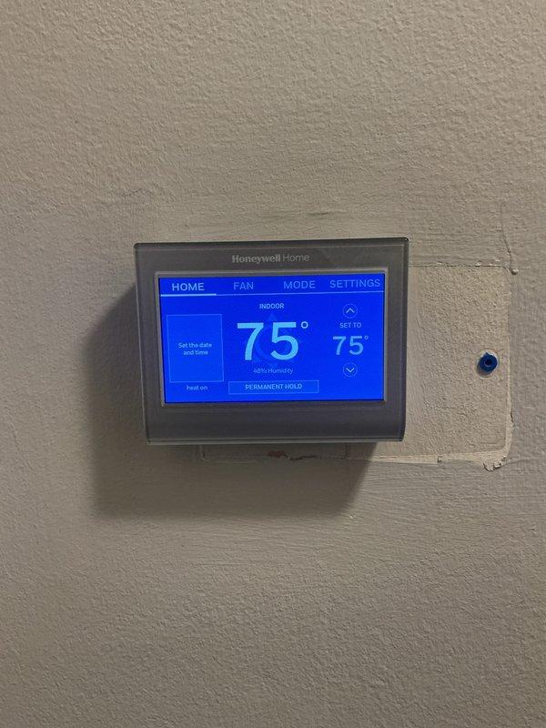 Completed comprehensive Gold Furnace Inspection on 2022 forced air heating system located in basement. Verified thermostat operation with Honeywell Home digital unit maintaining proper setpoint at 75°F with system actively heating. Performed multi-point inspection per gold service protocol including visual examination of furnace components, safety controls, and heat exchanger. Confirmed equipment operational status and documented system configuration with utility area containing tankless water heater and associated mechanical systems. All safety checks passed, certification requirements met, and unit found to be functioning within normal parameters for age and application.