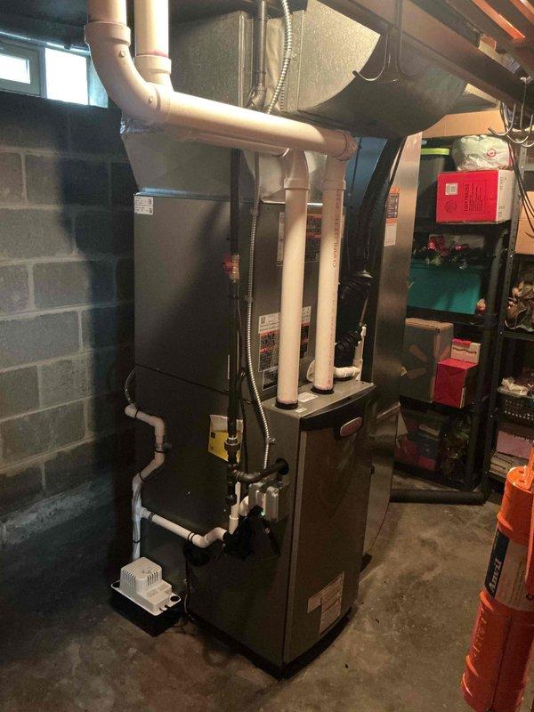 Completed full HVAC system installation including high-efficiency furnace, central air conditioning unit, and 50-gallon hot water heater in residential basement mechanical room. Installed all required PVC venting, condensate pump, ductwork modifications, and electrical connections per manufacturer specifications. Submitted permit documentation and utility rebate applications for energy-efficient equipment upgrade.