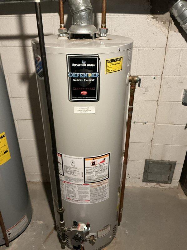 Completed scheduled maintenance on Honeywell 14kW standby generator and performed general purpose inspections on two residential furnaces located on the first floor and basement. Verified all equipment operational status, inspected electrical connections and control components, and documented system conditions through photographs including water heater installation and furnace electrical wiring assemblies.