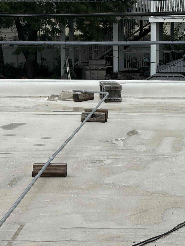 Responded to service call for rooftop unit not operating properly at commercial facility. Accessed RTU via ladder on flat membrane roof. Upon inspection, found unit's filter/coil section heavily contaminated with dirt and debris accumulation, restricting airflow and reducing system efficiency. Documented existing conditions showing significant soiling on coil guard and general unit maintenance needs. Unit requires thorough coil cleaning and filter replacement to restore proper operation and cooling capacity.