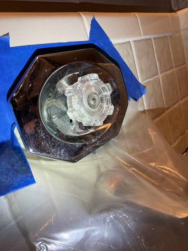Responded to service call for faulty tub diverter causing water leak to room below. Upon inspection, confirmed diverter valve failure was allowing water to bypass intended flow path and penetrate through flooring. Removed deteriorated diverter assembly and installed new replacement valve with brass fittings. Applied protective tape to surrounding tub surface during installation to prevent damage to porcelain finish. Tested new diverter operation to verify proper water flow direction between tub spout and shower head with no residual leaking. Confirmed leak remediation successful with no water migration to lower level.