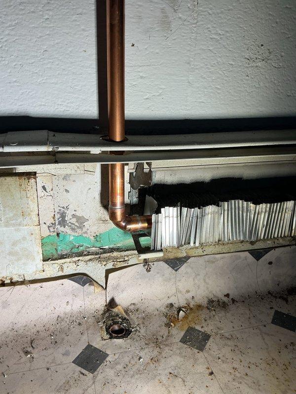Completed comprehensive boiler repair work in basement utility area per approved estimate. Addressed copper piping connections, including vertical supply lines and horizontal elbow joints, with replacement of corroded sections showing significant rust staining on walls and floor. Repaired radiator heat exchanger system and associated mounting hardware, ensuring proper functionality of heating distribution components. All work completed with financing documentation processed and signed by loan holder, with identification verified and retained on file.
