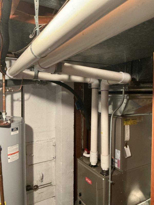 Completed comprehensive furnace inspection and replacement estimate for 10+ year old Bryant forced air system located in basement. Performed standard gold-level inspection protocol, replaced 20x25x4 air filter as requested, and documented existing equipment configuration including furnace unit, water heater, PVC venting system, and ductwork connections. Assessed current system condition and provided detailed replacement recommendations with photographic documentation of installation layout and mechanical components.