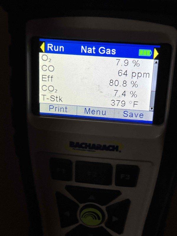 Completed Gold plan annual furnace maintenance on seven-year-old unit located in basement. Performed comprehensive tune-up including combustion analysis, which revealed acceptable operating parameters: oxygen level at 7.9%, carbon monoxide at 64 ppm, efficiency at 80.8%, carbon dioxide at 7.4%, and stack temperature at 379°F. Inspected interior components, blower assembly, and drainage system. All systems operating within manufacturer specifications with no issues identified. Unit in good working condition for continued operation.