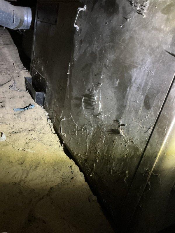 Responded to no heat call on 14-year-old furnace located in crawlspace with dirt floor, accessed through 2.5-foot opening in backyard. Upon inspection, found unit attempting to run with thermostat calling for heat. Examined blower assembly and housing, noting significant dust and debris accumulation on blower wheel and interior surfaces consistent with age and lack of maintenance. Assessed ductwork and mechanical components in confined crawlspace environment, documenting condition of aging equipment and contamination levels affecting system performance.