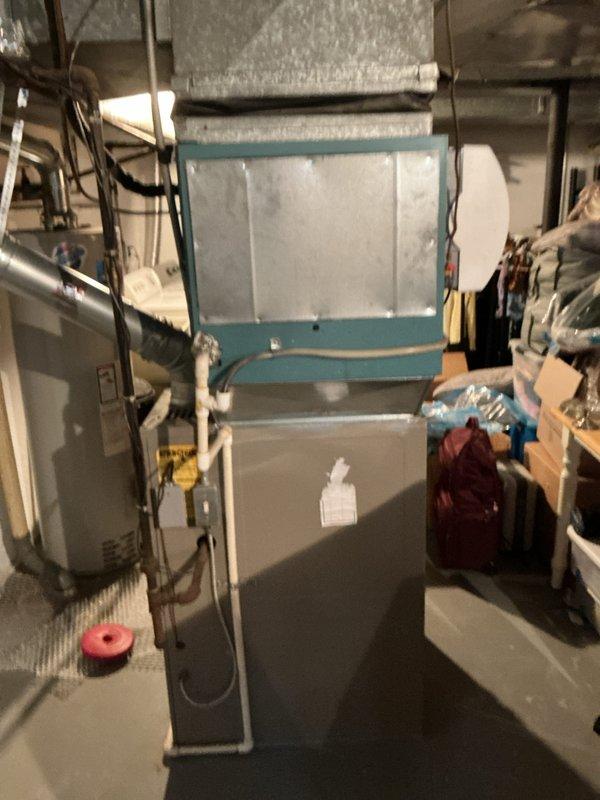 Conducted comprehensive assessment of existing HVAC system located in basement utility area for equipment replacement estimate. Evaluated current air handler unit with filter access panel, associated ductwork including metallic and flexible insulated sections, and natural gas furnace configuration. Documented equipment age, operational status, spatial constraints, and existing duct connections to provide accurate replacement specifications and installation requirements.