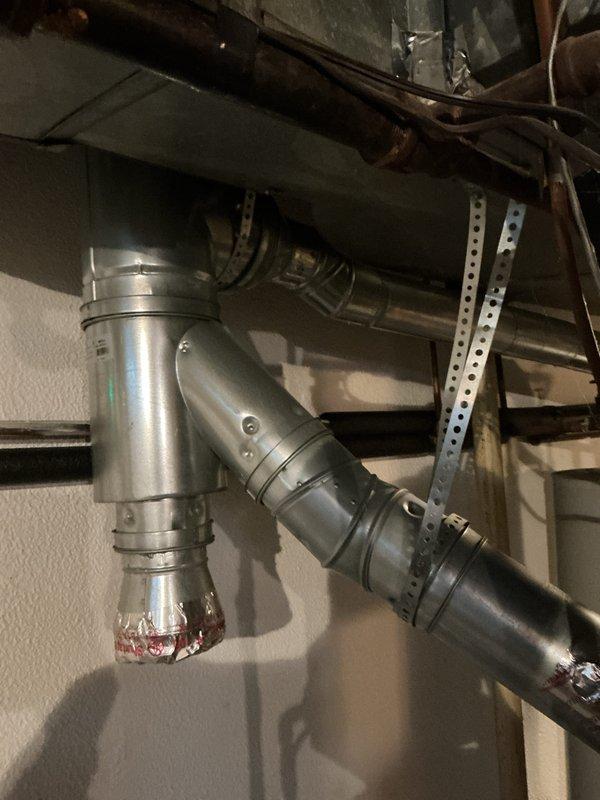 Conducted comprehensive assessment of existing HVAC system located in basement utility area for equipment replacement estimate. Evaluated current air handler unit with filter access panel, associated ductwork including metallic and flexible insulated sections, and natural gas furnace configuration. Documented equipment age, operational status, spatial constraints, and existing duct connections to provide accurate replacement specifications and installation requirements.