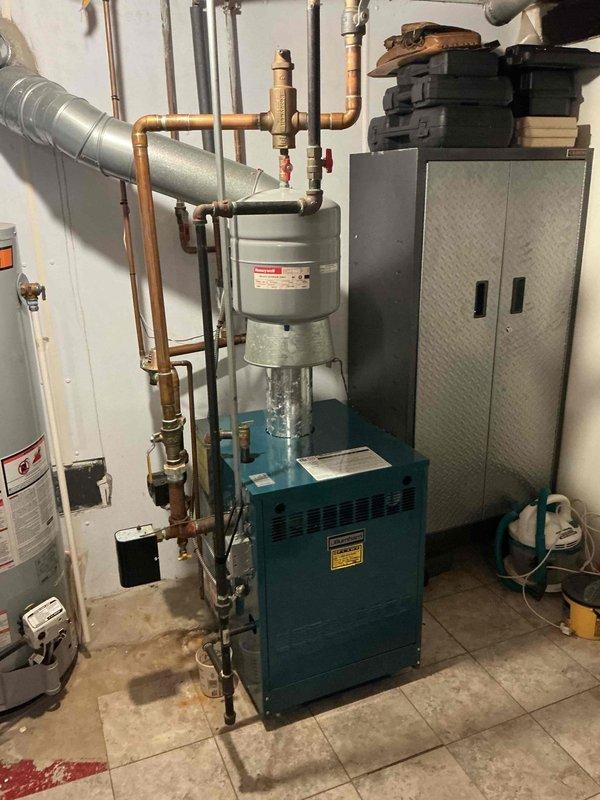 Completed annual Gold boiler inspection and cleaning on a 21-year-old Burnham 206NCL-GEI2 unit located in basement. Performed comprehensive tune-up including combustion analysis, heat exchanger inspection, burner cleaning, and safety control verification. All components operating within manufacturer specifications with no deficiencies noted. System ready for continued service with next maintenance scheduled for 2026.