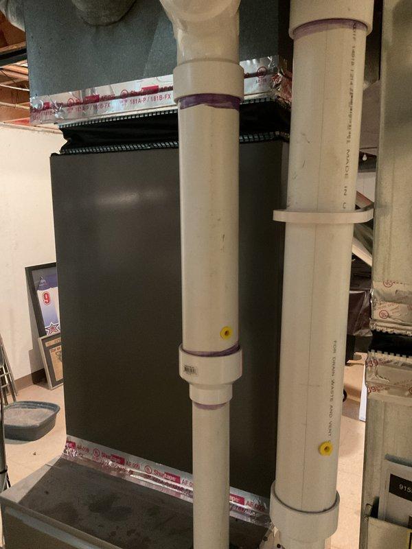 Completed installation of 4-ton air conditioning system with evaporator coil in residential basement utility area. Addressed height clearance issue identified during remeasure phase prior to installation. Installed new AC unit with left-side configuration, connected refrigerant lines with proper insulation, and integrated evaporator coil with existing furnace system. Routed PVC condensate drainage piping along floor with appropriate fittings and secured all connections. Coordinated electrical reconnection requirements for licensed electrician to complete. Mechanical permit obtained for HVAC components only. All equipment properly positioned, refrigerant lines installed with black insulation wrap, and system prepared for final electrical hookup and startup procedures.
