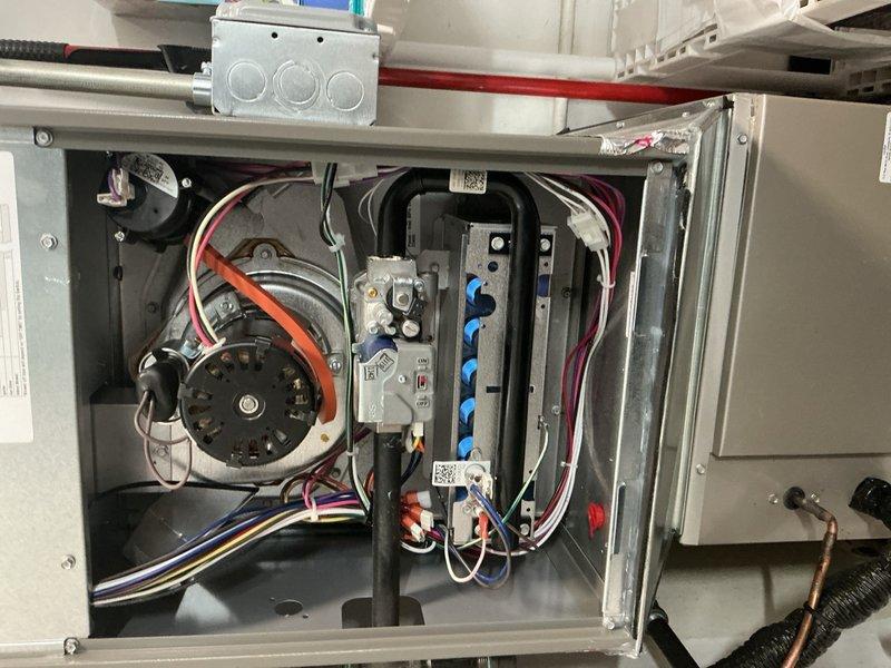 Completed comprehensive Gold-level furnace inspection on a 1-year-old forced air system located in the utility room. Performed thorough visual examination of all accessible components including blower motor assembly, electrical control panel, wiring connections, and safety controls. Inspected burner assembly, heat exchanger, gas connections, and venting system for proper operation and code compliance. Verified all electrical connections are secure with proper wire management throughout the control panel. Examined blower motor, capacitor, and relay systems for optimal performance. Confirmed thermostat communication and system cycling functions properly. All safety devices tested and functioning within manufacturer specifications. Unit operating efficiently with no deficiencies noted at time of inspection.