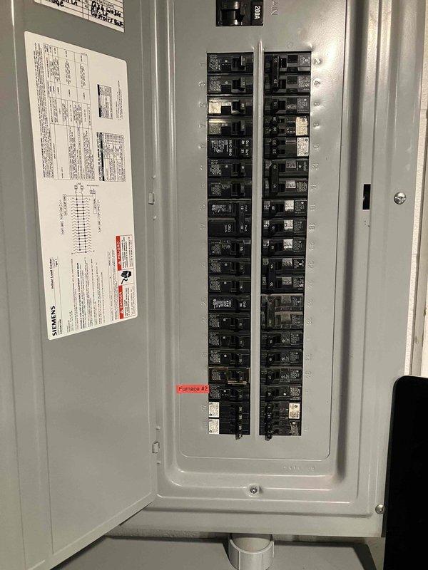 Responded to electrical code violation requiring proper labeling and equipment adjustment. Labeled all circuit breakers in the electrical panel with clear identification tags indicating corresponding circuits and equipment. Applied identification label to HVAC unit in attic space, marking it as "Furnace #2" for proper system identification. Adjusted furnace door covers to ensure proper closure and secure fit, correcting installation deficiency. All work completed to bring installation into compliance with local electrical code requirements and pass municipal inspection.