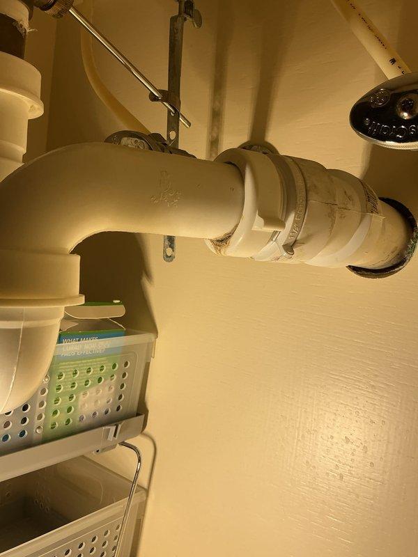 Responded to priority service call for leaking upstairs bathroom sink. Upon arrival, performed thorough inspection of sink plumbing assembly, including supply lines, drain connections, and trap configuration. Examined braided metal supply hoses, threaded pipe fittings, and compression connections for signs of water intrusion. Inspected white PVC P-trap assembly and drain stopper mechanism for proper sealing and alignment. Documented existing plumbing conditions with detailed photographs showing underside cabinet installation, including chrome faucet supply lines, drain flange assembly, and all connection points. Identified source of leak and completed necessary repairs to restore proper function and eliminate water seepage. Tested all connections under pressure to verify leak resolution and ensure system integrity.