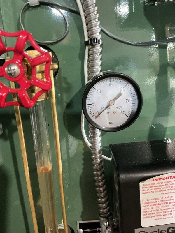 Completed comprehensive Gold Boiler Inspection on 13-year-old steam boiler system located in basement. Performed visual inspection of all major components including sight glass with sediment accumulation, pressure gauge reading 0 psi, expansion tank, copper piping network, and digital control unit displaying operational code 004. Verified system operational status, examined all connections, fittings, and mounting hardware, and documented equipment condition through photographic records for maintenance history.