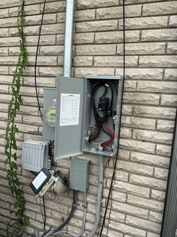 Completed full electrical service upgrade including installation of new 100-amp Siemens main electrical panel mounted on exterior brick wall. Ran new electrical conduit from meter base to panel, installed weatherproof disconnect box, and established one new dedicated circuit. All wiring terminated per code specifications with proper grounding and bonding, panel labeled accordingly, and system tested for proper operation upon completion.