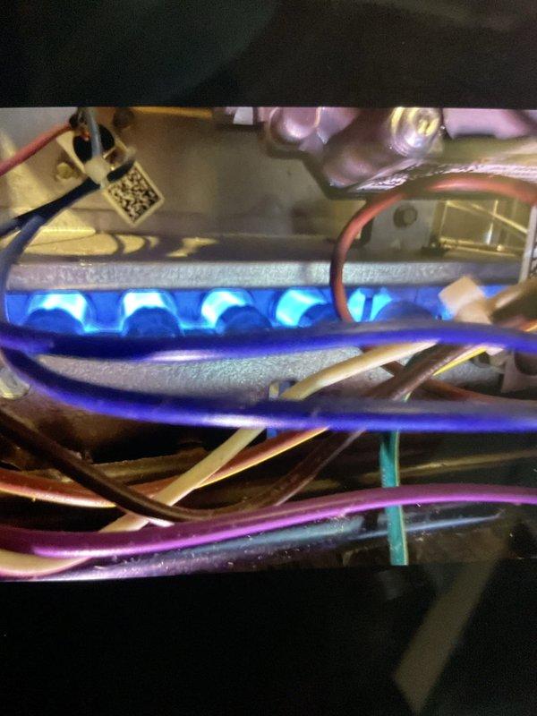 Completed comprehensive tune-up and city certification inspection on 3-year-old forced air furnace located in basement. Performed full system evaluation including burner assembly inspection, confirmed proper ignition sequence and flame characteristics showing consistent blue flame across all burner ports, verified all electrical connections and wiring integrity, and tested safety controls. Informed customer that cold air return capping falls outside our scope of service as we do not perform ductwork modifications.