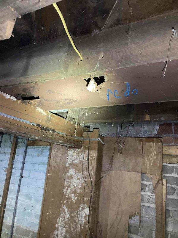 Conducted estimate for furnace replacement in basement location where existing unit is non-operational. Assessment revealed significant structural deterioration in installation area, including damaged wooden beams, compromised ceiling materials with visible breaches, and exposed wall cavities requiring remediation prior to new equipment installation. Documented extensive pre-existing conditions including moisture damage, deteriorated framing members, and compromised ductwork that will need to be addressed as part of complete system replacement.
