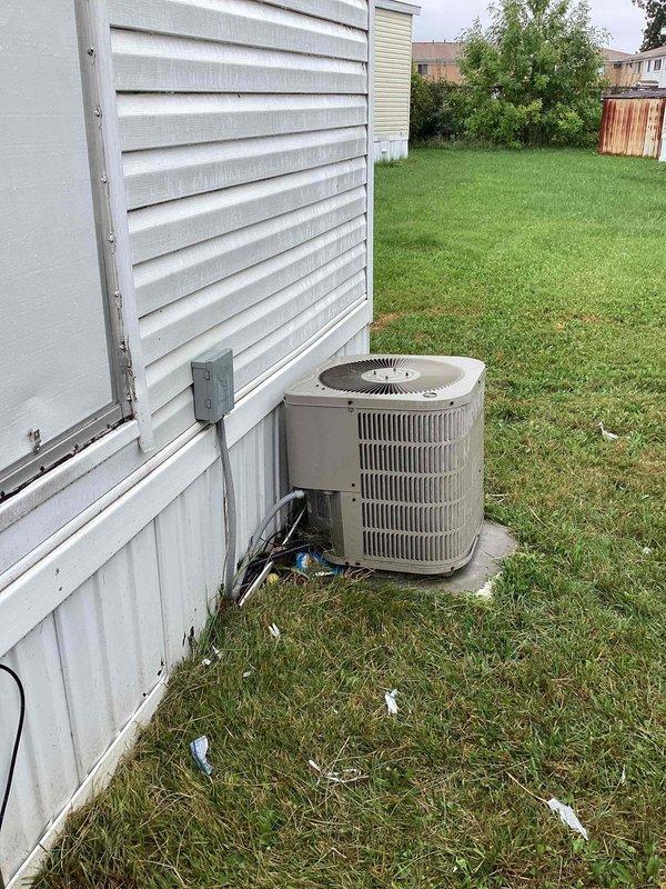 Responded to service call for furnace not kicking on after recent service. Performed thorough diagnostic inspection of main floor heating unit and thermostat system. Upon evaluation of the existing equipment age and condition, provided comprehensive estimate for complete HVAC system replacement including both furnace and air conditioning condenser unit. Documented current installation with exterior condenser unit on concrete pad and interior electrical panel configuration for replacement planning purposes.
