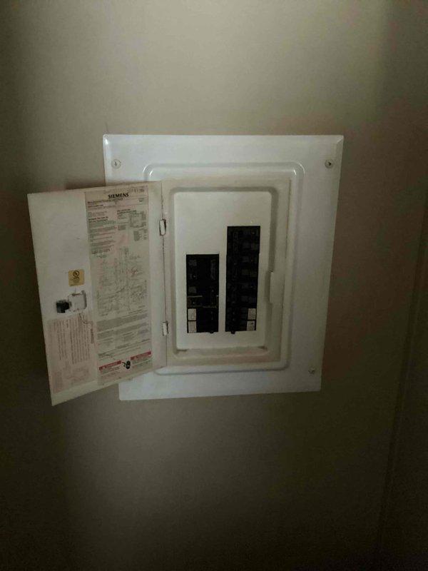 Responded to service call for furnace not kicking on after recent service. Performed thorough diagnostic inspection of main floor heating unit and thermostat system. Upon evaluation of the existing equipment age and condition, provided comprehensive estimate for complete HVAC system replacement including both furnace and air conditioning condenser unit. Documented current installation with exterior condenser unit on concrete pad and interior electrical panel configuration for replacement planning purposes.