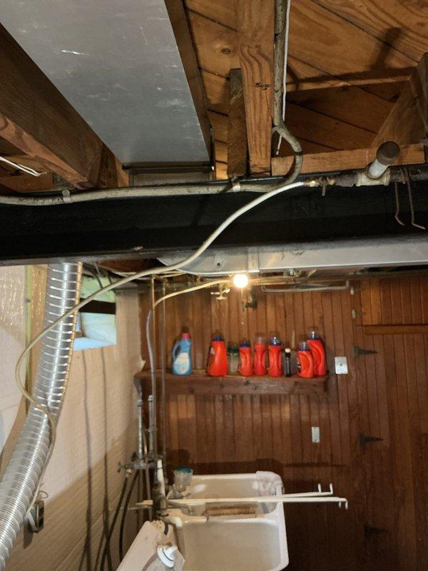 Conducted on-site assessment of residential gas piping system in response to reported leak affecting bathroom area with migration to basement space. Evaluated existing gas line serving dryer appliance and identified compromised piping requiring replacement. Inspected basement utility area including exposed ceiling-mounted gas lines, plumbing infrastructure, and ventilation ductwork to determine extent of leak and optimal routing for new gas line installation. Documented existing conditions of galvanized and flexible gas piping, noted proximity to PVC plumbing and HVAC ductwork, and assessed accessibility for safe gas line replacement. Provided comprehensive estimate for complete gas line replacement from main supply to dryer connection point, ensuring compliance with current gas fitting codes and safety standards.