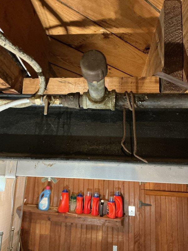 Conducted on-site assessment of residential gas piping system in response to reported leak affecting bathroom area with migration to basement space. Evaluated existing gas line serving dryer appliance and identified compromised piping requiring replacement. Inspected basement utility area including exposed ceiling-mounted gas lines, plumbing infrastructure, and ventilation ductwork to determine extent of leak and optimal routing for new gas line installation. Documented existing conditions of galvanized and flexible gas piping, noted proximity to PVC plumbing and HVAC ductwork, and assessed accessibility for safe gas line replacement. Provided comprehensive estimate for complete gas line replacement from main supply to dryer connection point, ensuring compliance with current gas fitting codes and safety standards.