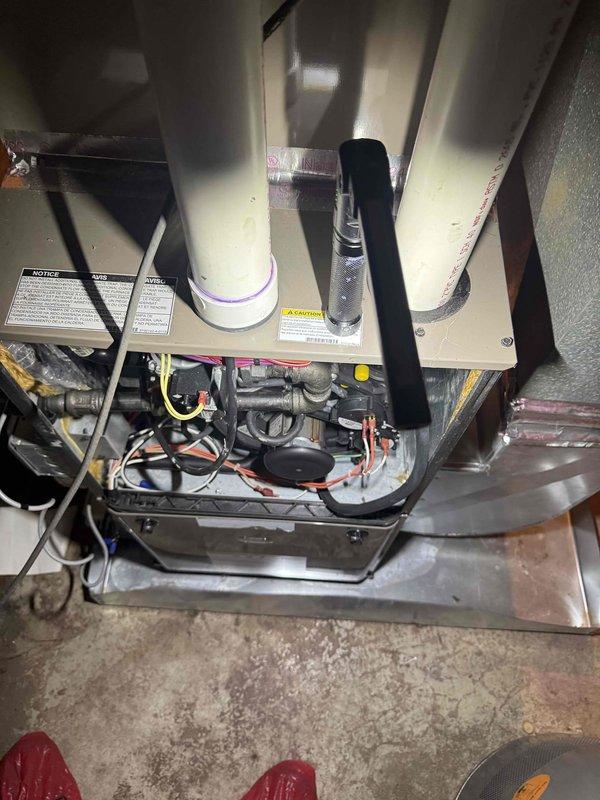 Responded to service call for 2-year-old furnace system not producing adequate heat in basement installation. Upon arrival, performed comprehensive system inspection revealing significant condensation accumulation on supply ductwork and air handler components. Removed access panel to examine internal components including blower assembly, heat exchanger, and control wiring. Inspected evaporator coil condition and verified refrigerant line connections for proper operation. Evaluated air handler electrical connections, safety controls, and thermostat communication circuits. Documented excessive moisture presence on ductwork exterior, indicating potential airflow restriction or humidity imbalance affecting system performance. Checked condensate drainage system and verified proper operation of drain lines and pan. Assessed insulation integrity around installation area and identified areas of concern related to moisture infiltration. Verified all safety switches, limit controls, and flame se