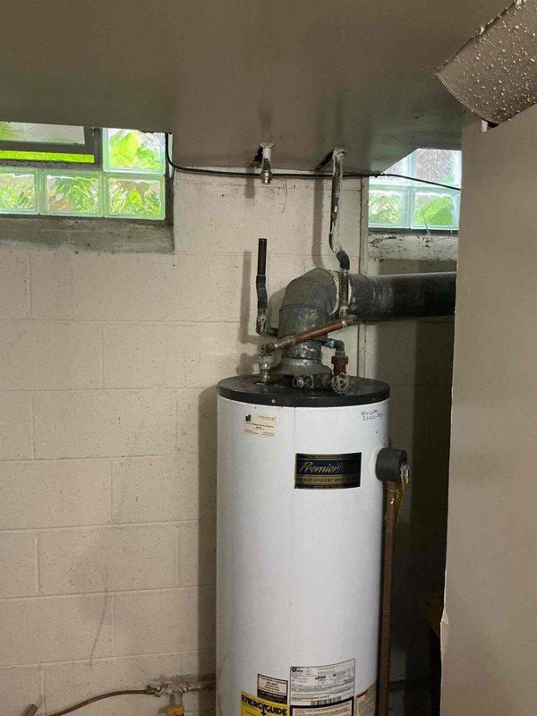Responded to service call for leaking tanked water heater originally installed in 2007. Performed on-site assessment of Premier brand water heater unit showing signs of age-related deterioration and active leak condition. Documented existing installation including copper supply lines, pressure relief valve, venting configuration, and drain pan placement. Evaluated chimney liner requirements for proper venting of replacement unit and confirmed specifications with homeowner. Provided comprehensive replacement estimate covering removal of failed unit and installation of new tanked water heater system with all necessary connections and code-compliant venting. Estimate was accepted for full water heater replacement to resolve leak issue and restore domestic hot water service.