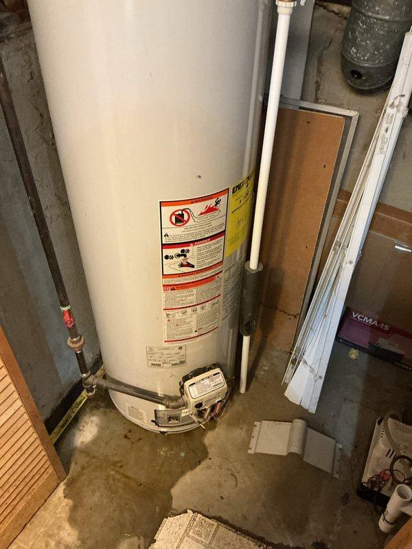 Responded to service call for water leak from 20-year-old Lochinvar hot water heater located in basement with no hot water available. Upon inspection, identified active leak and loss of gas supply to unit. Assessed condition of aging water heater including all plumbing connections, gas line, temperature/pressure relief valve, and control components to determine source of leak and gas interruption.