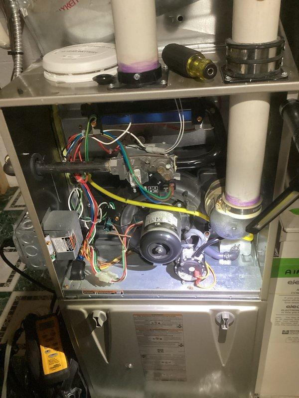 Completed comprehensive Gold-level furnace inspection on 2006 heating system located in basement. Performed thorough examination of all internal components including blower motor assembly, burner chamber, heat exchanger, electrical connections, and control board. Inspected venting system with PVC exhaust and intake piping, verified proper condensate drainage, and examined Healthy Climate air filtration system (20" × 25" × 5" filter). All safety controls, gas connections, and wiring harnesses tested and found operational within manufacturer specifications.