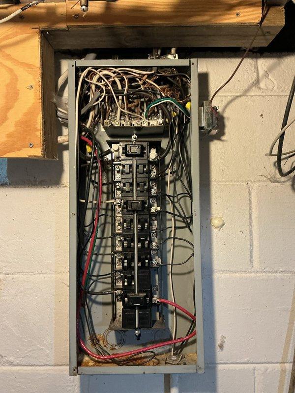 Performed electrical panel assessment for circuit breaker replacement and generator outlet installation. Inspected existing electrical panel containing dual vertical columns of circuit breakers with multiple wire connections entering from top of enclosure. Evaluated panel capacity, breaker conditions, and wiring configuration to provide accurate quote for requested circuit breaker replacement and dedicated generator receptacle installation.