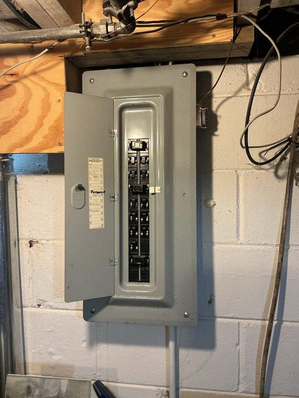 Performed electrical panel assessment for circuit breaker replacement and generator outlet installation. Inspected existing electrical panel containing dual vertical columns of circuit breakers with multiple wire connections entering from top of enclosure. Evaluated panel capacity, breaker conditions, and wiring configuration to provide accurate quote for requested circuit breaker replacement and dedicated generator receptacle installation.