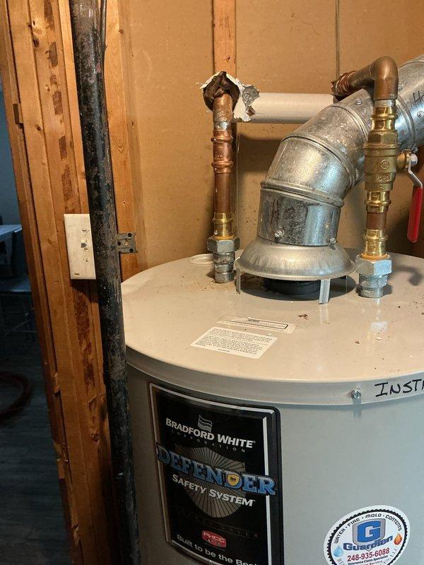 Completed anode rod replacement and full water heater flush on Bradford White Defender Safety System unit. Retrieved replacement anode rod from Ferguson Supply Center per purchase order #1371393. Drained water heater tank completely using utility sink, removing sediment buildup and rust-colored deposits that had accumulated at tank bottom. Removed deteriorated anode rod from top of unit and installed new replacement rod to restore corrosion protection for tank interior. Refilled water heater, purged air from system through hot water fixtures, and verified proper operation of all connections and safety components. Unit returned to full service with extended tank life expectancy due to preventative maintenance performed.