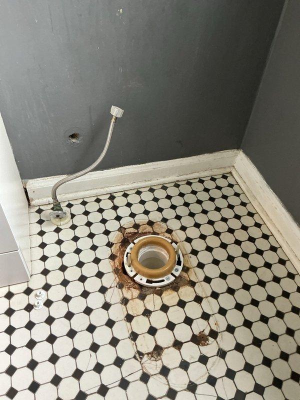 # Stack Replacement

Completed full stack replacement from basement to first floor bathroom. Removed corroded toilet flange showing significant rust damage and deterioration that had stained surrounding hexagonal tile flooring. Disconnected and removed existing vertical drain stack system. Installed new PVC drainage stack running from basement level through ceiling joists to first floor bathroom. Secured all vertical piping to wall structure per code requirements. Installed new brass toilet flange at floor level, ensuring proper elevation and secure mounting for toilet reinstallation. Tested all connections for leaks and verified proper drainage flow throughout the system. Left work area clean with new stack system fully operational and ready for fixture installation.