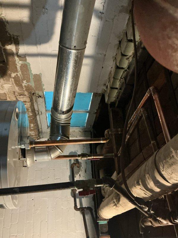 Completed waterline repairs in basement utility area as specified in estimate. Worked with existing copper plumbing system and galvanized ductwork in mechanical room with white painted brick walls. Repairs addressed compromised waterline components, ensuring proper function and integrity of the residential plumbing infrastructure.