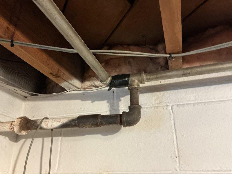 Responded to report of gas leak in basement area. Upon inspection, identified small leak at galvanized steel pipe joint. Temporarily secured affected joint with repair tape as interim safety measure. Performed pressure test to verify leak location and assess system integrity. Recommended permanent repair or replacement of aging galvanized gas piping due to visible oxidation and deterioration of existing infrastructure.