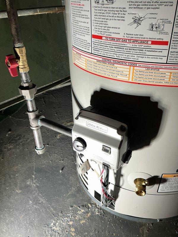 Responded to red-tagged gas leak on tanked water heater unit installed in 2023. Gas utility had identified and tagged leak at gas control valve assembly following initial service visit where no leak was detected. Upon arrival, confirmed gas leak at control valve unit under part warranty coverage. Removed existing white gas control valve assembly including pilot light mechanism, ignition system wiring, and brass gas line connections. Retrieved replacement gas valve from supplier under existing purchase order and installed new control valve assembly. Reconnected all gas piping, pilot assembly, ignition wiring, and thermostat controls. Performed leak test on all gas connections using approved testing solution to verify system integrity. Cycled unit through complete ignition sequence to confirm proper burner operation and flame sensor functionality. Verified temperature control operation and proper combustion chamber function. System restored to full operational status with no gas leaks de