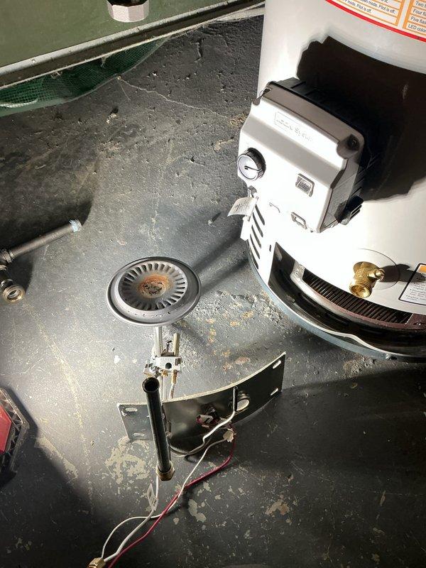 Responded to red-tagged gas leak on tanked water heater unit installed in 2023. Gas utility had identified and tagged leak at gas control valve assembly following initial service visit where no leak was detected. Upon arrival, confirmed gas leak at control valve unit under part warranty coverage. Removed existing white gas control valve assembly including pilot light mechanism, ignition system wiring, and brass gas line connections. Retrieved replacement gas valve from supplier under existing purchase order and installed new control valve assembly. Reconnected all gas piping, pilot assembly, ignition wiring, and thermostat controls. Performed leak test on all gas connections using approved testing solution to verify system integrity. Cycled unit through complete ignition sequence to confirm proper burner operation and flame sensor functionality. Verified temperature control operation and proper combustion chamber function. System restored to full operational status with no gas leaks de