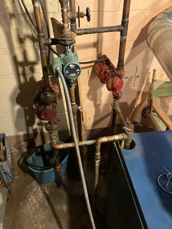 Provided estimate for replacement of non-operational 16-year-old natural gas boiler located in basement. Assessed existing hydronic heating system including circulation pump, zone valves, expansion tank, and interconnected copper and black iron piping network. Documented current equipment configuration and mechanical room layout to prepare comprehensive replacement proposal for new boiler system.