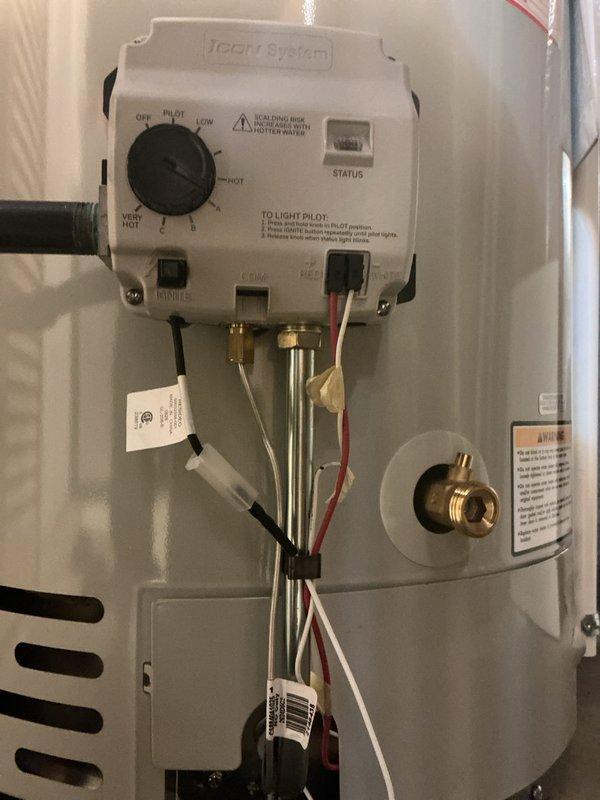Completed installation of a standard 40-gallon Bradford White gas water heater in residential utility closet. Unit was properly positioned, connected to existing copper supply lines, equipped with expansion tank and pressure relief valve, and all gas connections were made with Honeywell gas control system featuring pilot ignition and temperature regulation. All plumbing connections were secured, system was tested for proper operation, and installation meets code requirements.
