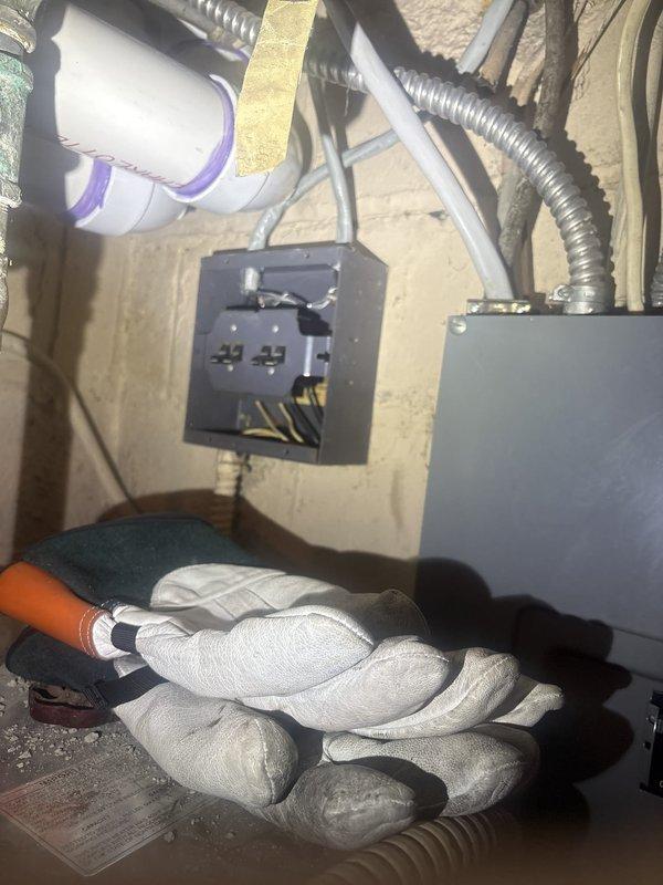 Responded to service call for incorrectly routed wiring from dual meter boxes causing hot water heater malfunction. Upon inspection, identified crossed conductors in basement electrical panel affecting water heater circuit. Traced wiring from both meter boxes through conduit runs to panel, verified proper phasing and circuit assignments. Corrected wire routing at panel connections, ensuring proper hot and neutral conductor assignments to water heater circuit. Secured all wire connections with appropriate wire nuts, verified voltage at water heater terminals, and confirmed proper operation of unit upon restoration of power.