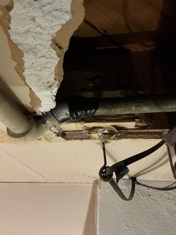 Responded to gas leak emergency where utility company had identified leak location and installed temporary repair. Performed comprehensive gas pressure test and leak detection inspection of natural gas piping system. Located active leak in gas line running through damaged wall section with exposed framing and deteriorated building materials. Assessed compromised gas line integrity in area showing significant structural damage and water intrusion issues. Documented leak location and surrounding conditions including exposed piping, damaged drywall, and compromised building envelope. Provided permanent repair solution to replace temporary utility company fix and restore safe gas service to property.