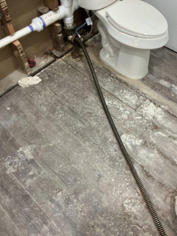 Responded to main drain blockage with cable retrieval and video inspection services. Upon arrival, accessed main sewer line through exterior cleanout access point visible in gravel surface area near structure. Successfully extracted previously lodged drain snake that had become stuck in the line during prior clearing attempt. Performed comprehensive camera inspection of main drain line to assess condition and verify complete removal of obstruction. Video documentation revealed no remaining foreign objects or significant line damage. Inspected interior plumbing connections and drainage system through bathroom access point, confirming proper flow restoration throughout the system. All extracted equipment and debris removed from property, cleanout secured, and drainage system returned to full operational status.