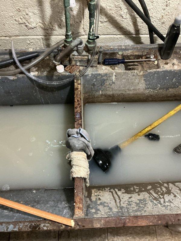 Responded to service call for clogged laundry sink caused by debris from installation tools being rinsed in the fixture. Cleared blockage from drain line and restored proper drainage. Additionally installed Resideo water sensor near water heater for leak detection and monitoring purposes.
