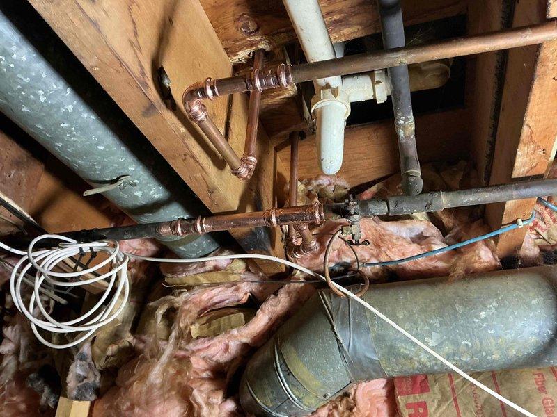 Replaced defective Gerber tub spout diverter mechanism in accordance with approved estimate. Accessed plumbing through attic crawl space where aging copper supply lines and existing valve assembly were inspected. Removed old chrome tub spout with malfunctioning diverter lever and installed new Gerber replacement unit, ensuring proper seal and function for directing water flow between tub spout and shower head.