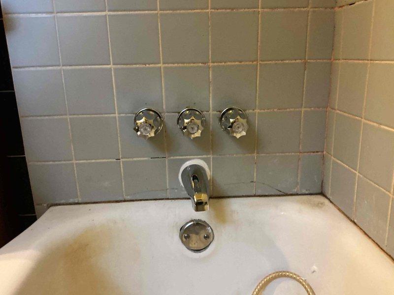 Replaced defective Gerber tub spout diverter mechanism in accordance with approved estimate. Accessed plumbing through attic crawl space where aging copper supply lines and existing valve assembly were inspected. Removed old chrome tub spout with malfunctioning diverter lever and installed new Gerber replacement unit, ensuring proper seal and function for directing water flow between tub spout and shower head.