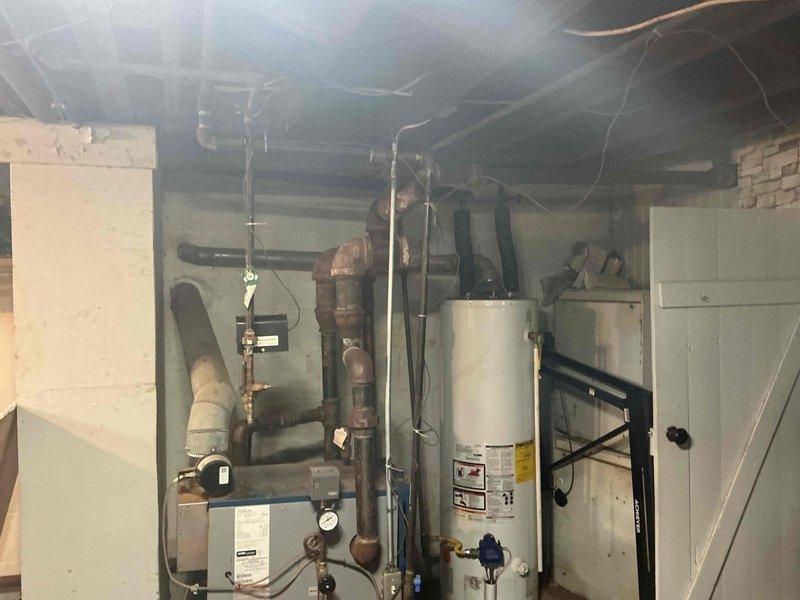 Responded to emergency gas service call where utility company had shut off gas supply and tagged six separate leak locations in basement mechanical area. Conducted comprehensive pressure testing and leak assessment of existing gas piping system, including aged copper supply lines, connections at water heater, and distribution piping throughout basement space. Documented all tagged leak points for repair evaluation and provided technical assessment to restore safe gas service to residence.
