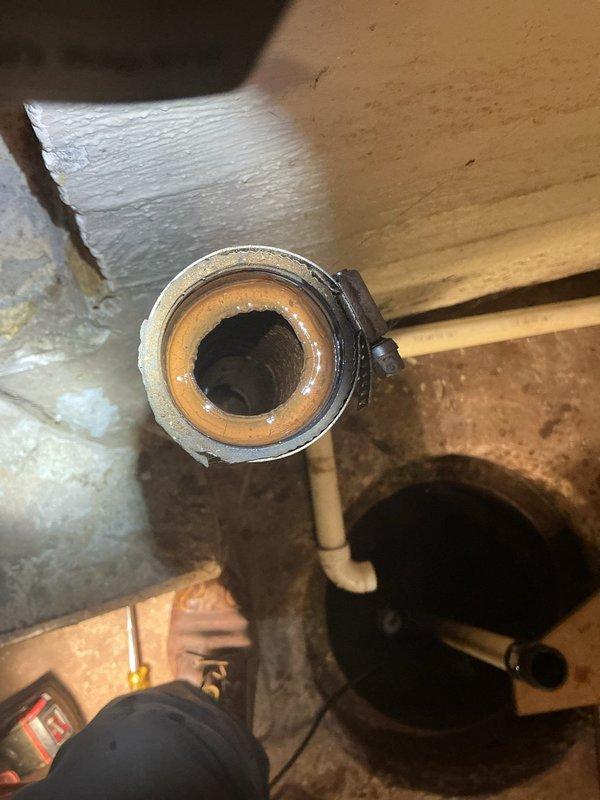 Responded to service call for sump pump replacement initially identified by HVAC technician. Removed existing failed sump pump unit and installed new replacement pump in basement sump pit. Connected discharge piping using PVC and flexible connections with stainless steel hose clamps and green coupling adapter to ensure proper water evacuation from pit. Verified pump operation, tested float switch functionality, and confirmed proper drainage through existing discharge line. System operational upon completion.