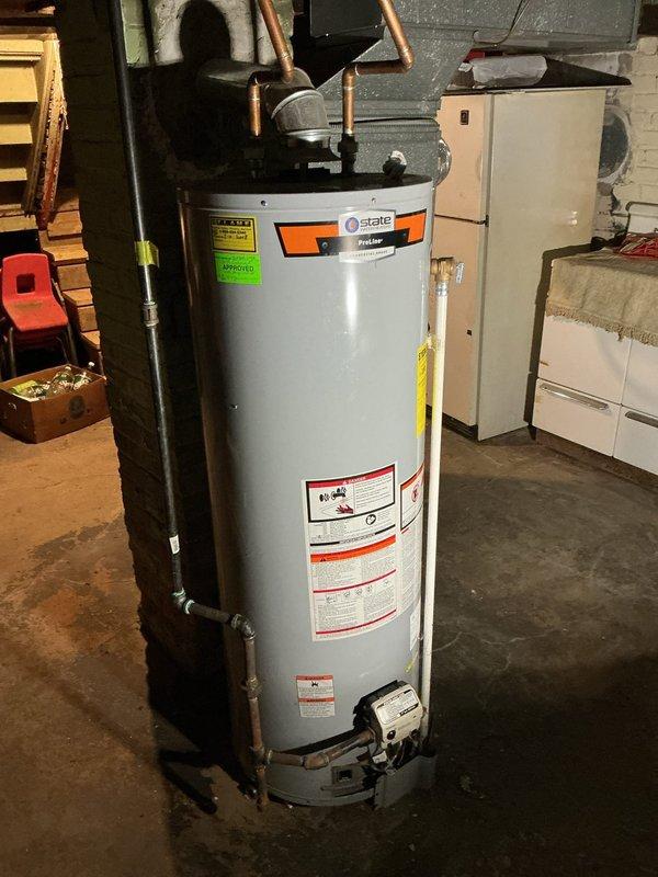 Returned to property following gas service restoration to assess 2018 State water heater previously installed under 10-year warranty. Upon inspection, confirmed tank failure with active leak at bottom of unit causing significant water pooling and moisture damage to basement concrete floor. Determined tank was not repairable due to compromised integrity of vessel. Removed failed 40-gallon gas water heater and installed new 40-gallon State brand gas water heater as warranty replacement. Connected all gas supply lines, water supply and discharge piping with copper connections. Verified proper venting configuration and clearances. Filled tank, purged air from system, and tested all connections for leaks. Lit pilot, verified burner operation, and confirmed proper heating cycle. Reviewed operation and maintenance requirements with homeowner. Unit operating properly at time of departure with no leaks detected.